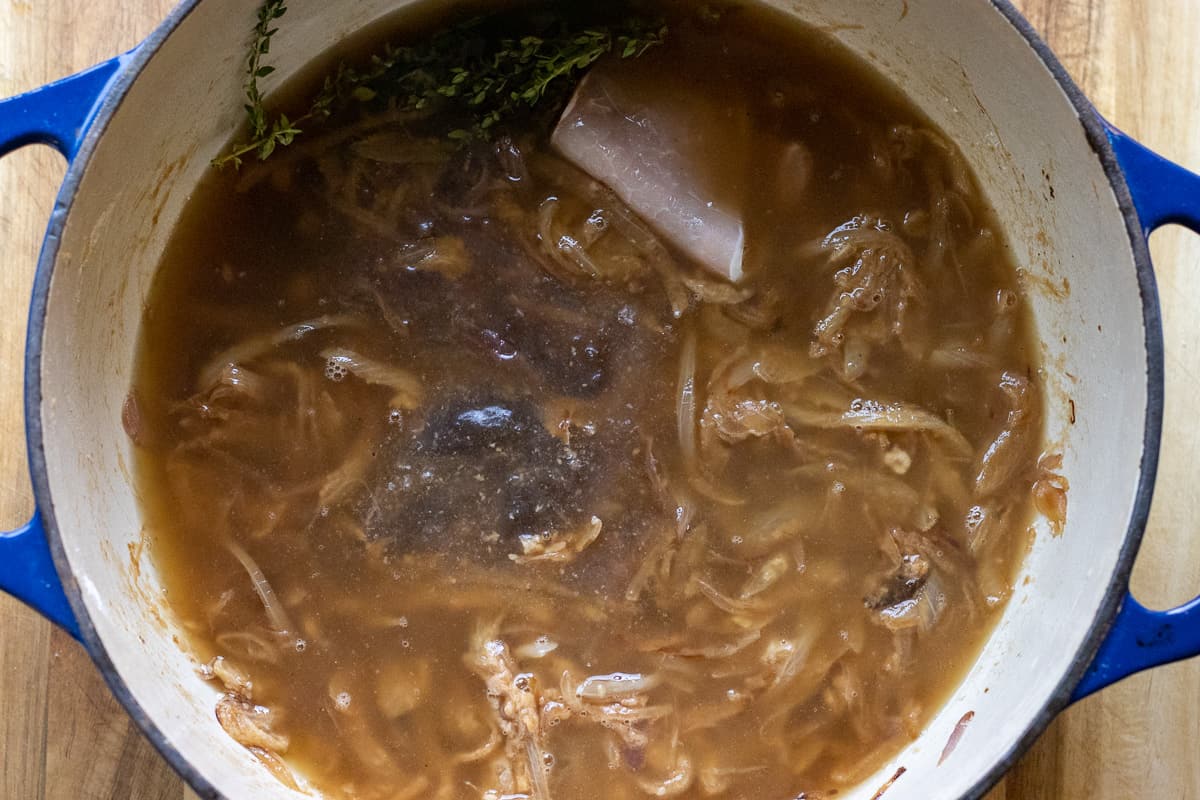 rest of the stock is added along with bacon, bay leaves and thyme