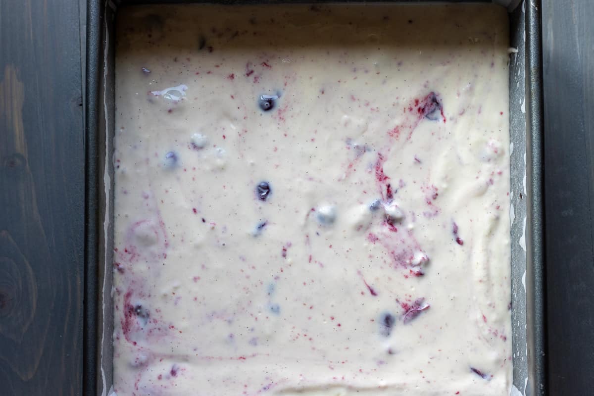 cranberry Cheesecake mixture is poured over chocolate brownie batter