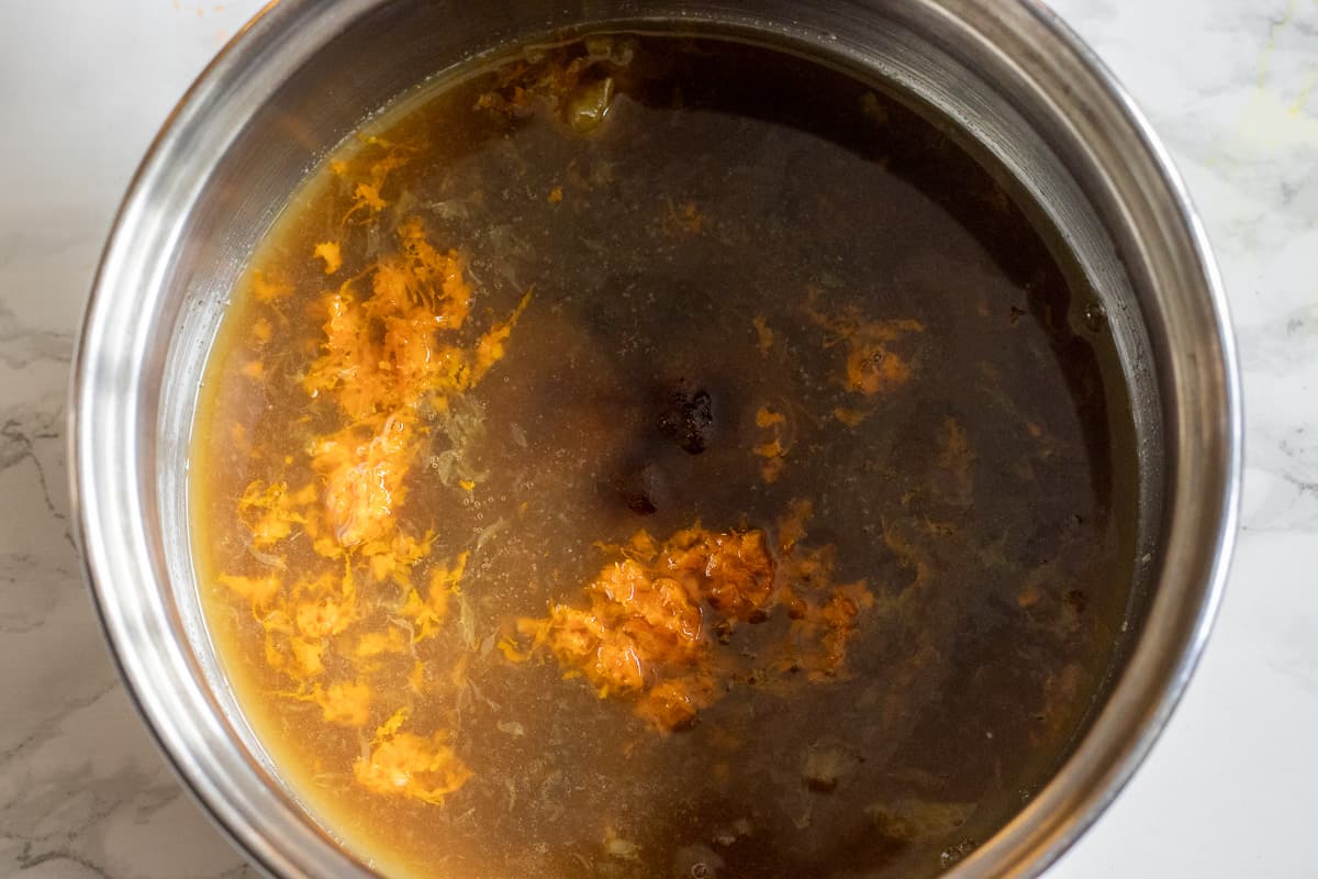 orange juice, zest and sugar are placed in a pan