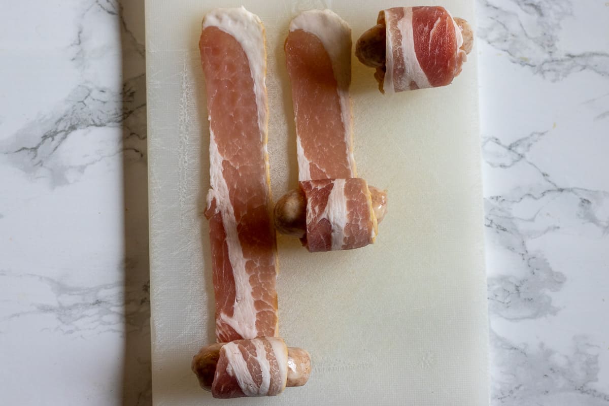 wrapping the streaky bacon around a cocktail sausage