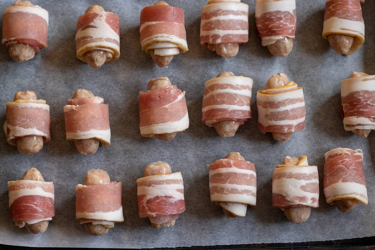 pigs in a blanket layer on a baking sheet