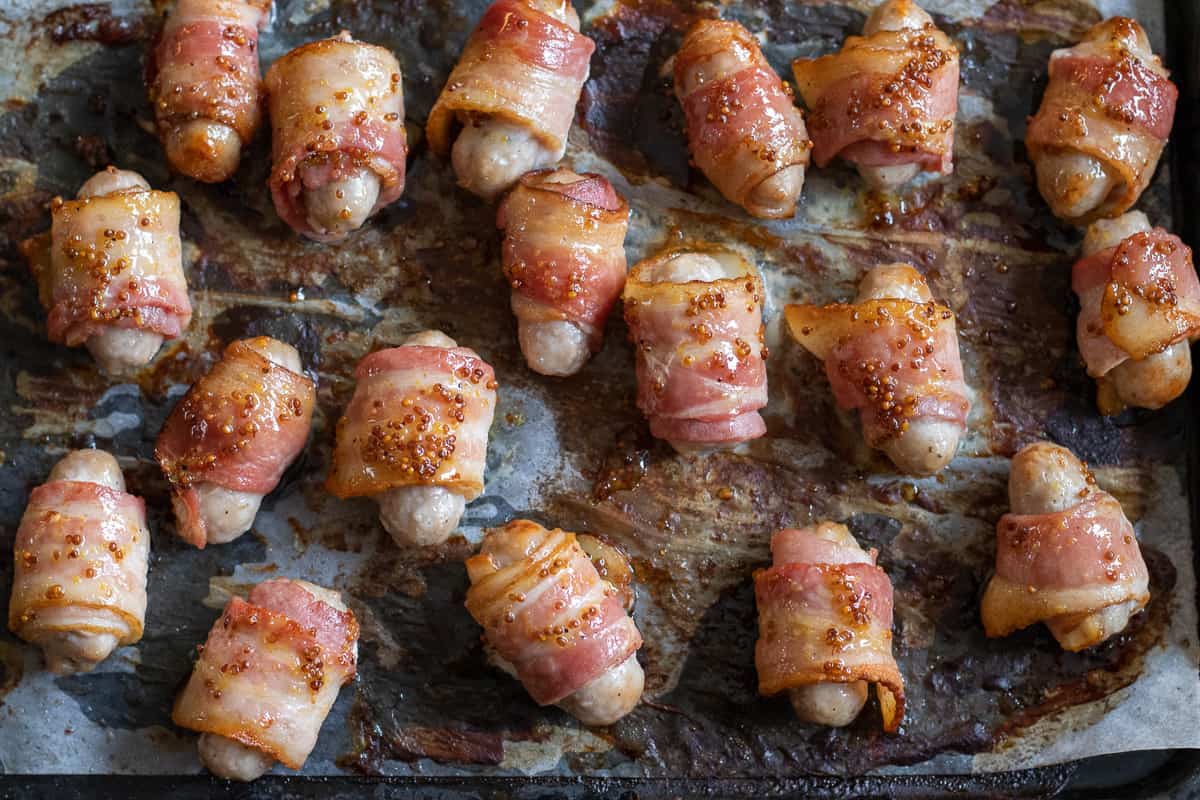 pigs in a blanket are glazed with honey and mustard