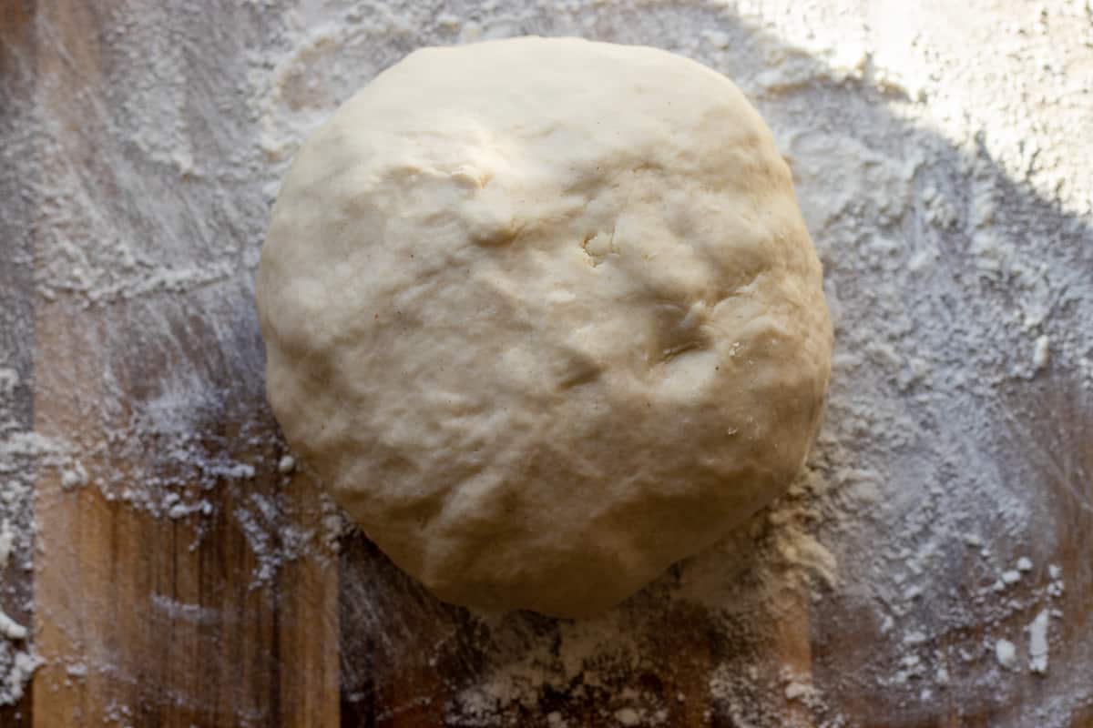 tortilla dough is turned into a ball before resting it