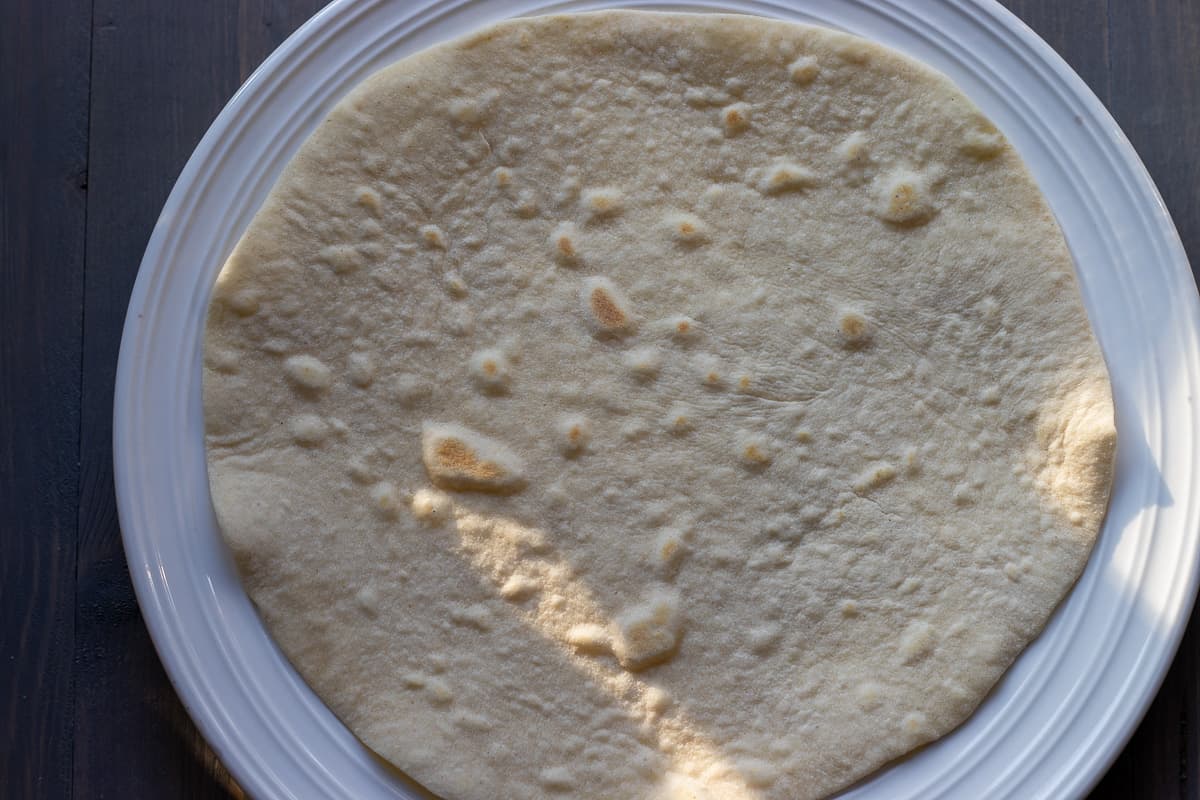 Freshly cooked tortilla bread is placed on a plate