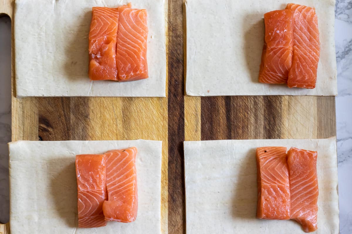 2 small salmon pieces are placed on each of puff pastries