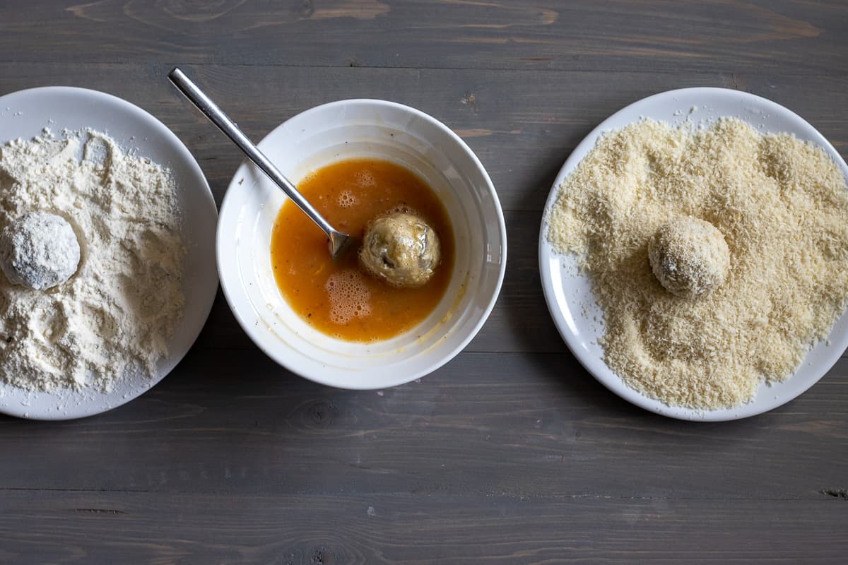 covering the rice balls with flour, egg and breadcrumbs
