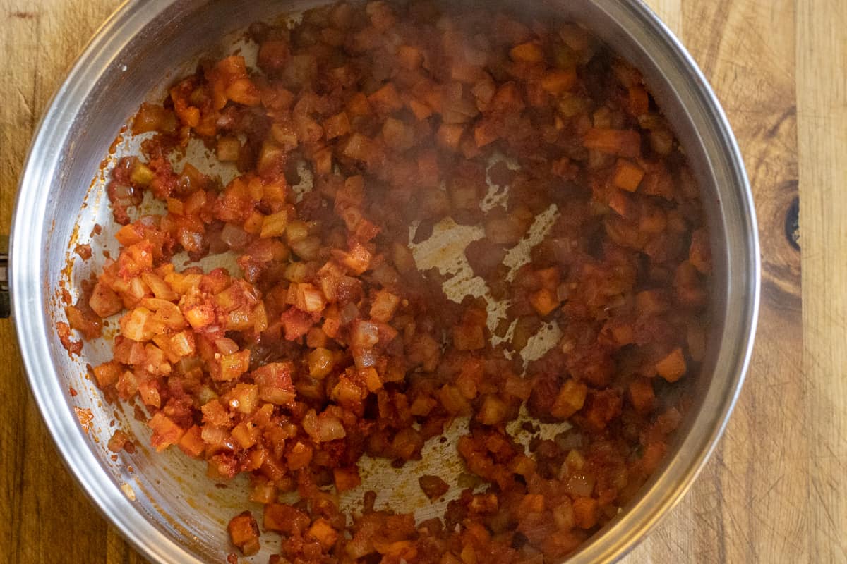 the vegetables are sautéed with the tomato paste and spices