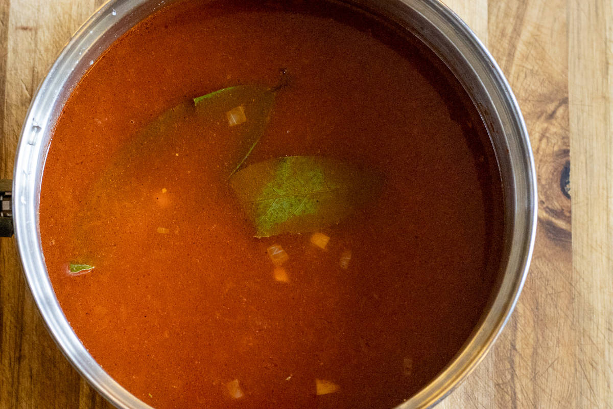 lentils, stock and bay leaves are added to the pan