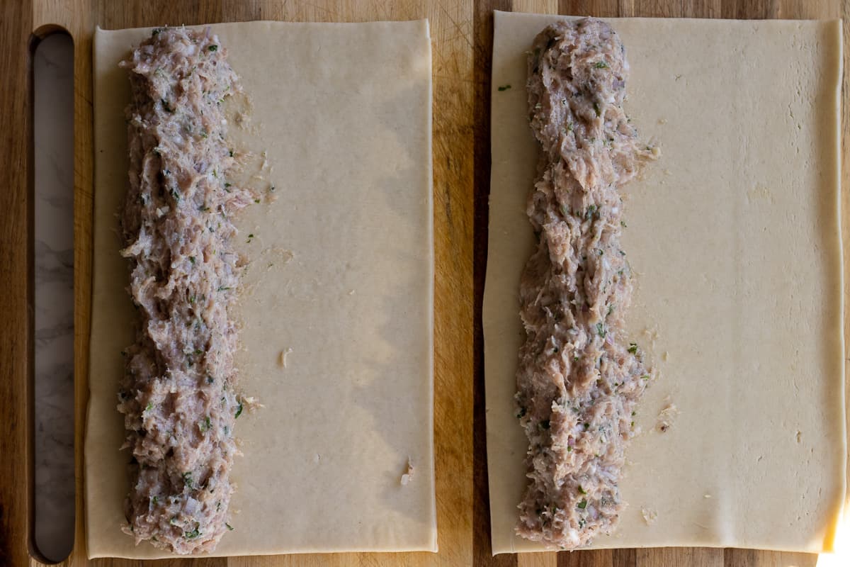 sausage mixture is spread along the long side of the pastries