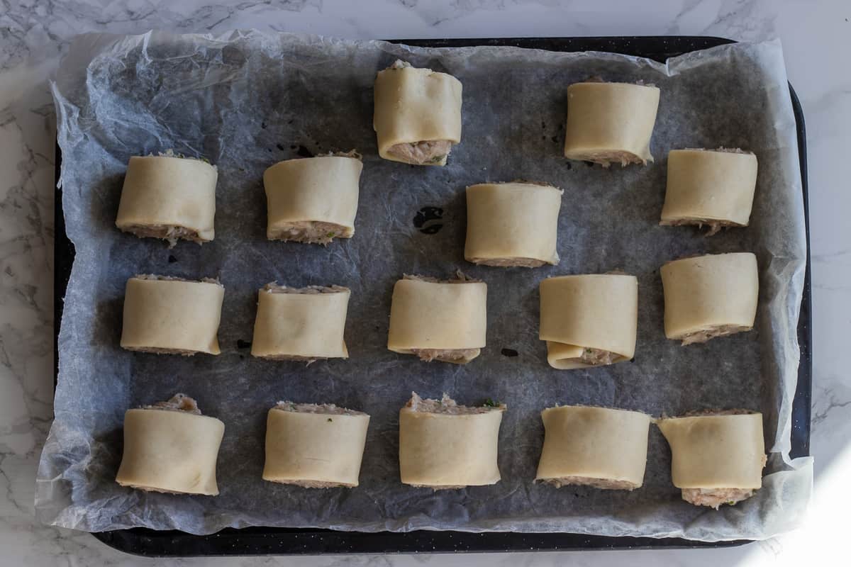 mini sausage rolls are placed on a tray