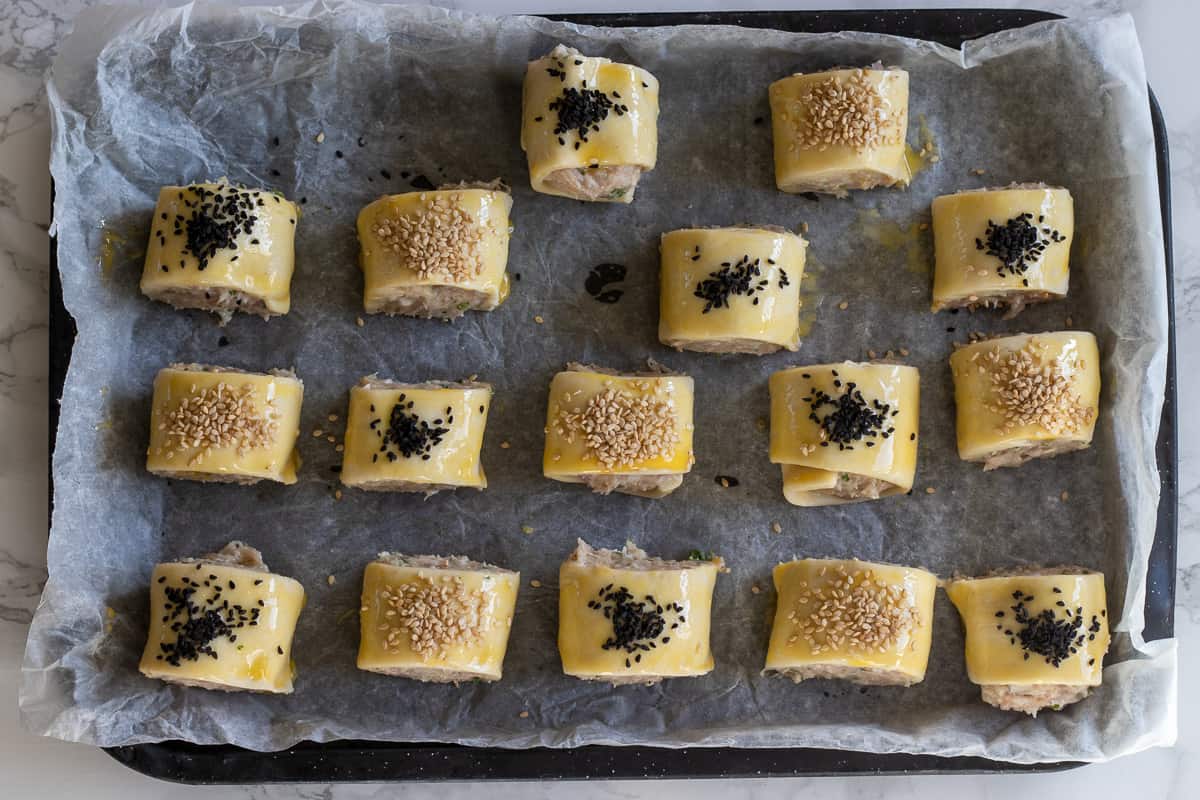 mini sausage rolls are brushed with egg wash