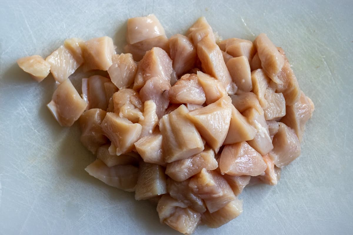 The chicken is cut into small cubes.