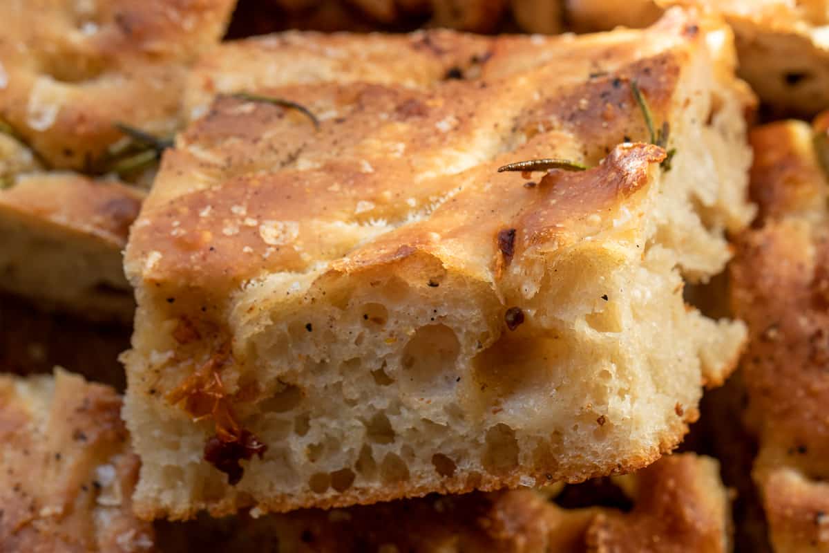 A slice of black pepper sourdough focaccia bread.