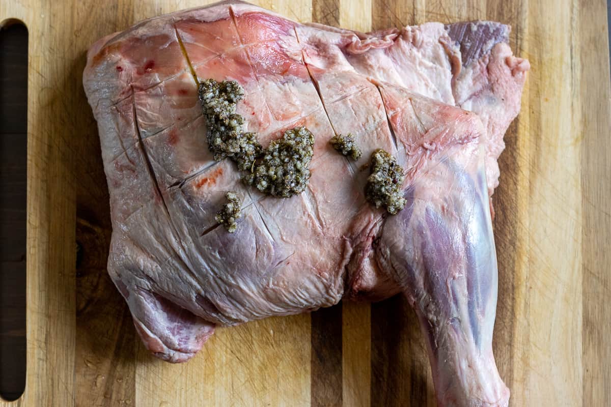 the spice mixture is placed on lamb shoulder