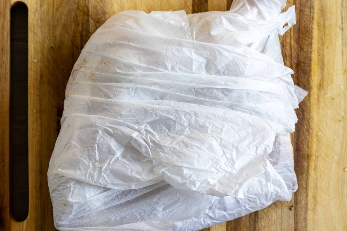 lamb shoulder is wrapped in 2 layers of parchment papers