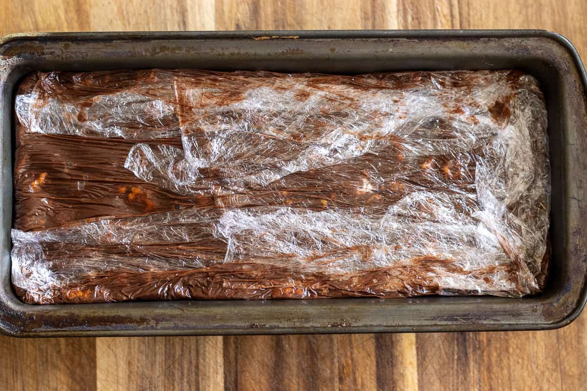 The cake is covered with overhanging cling film