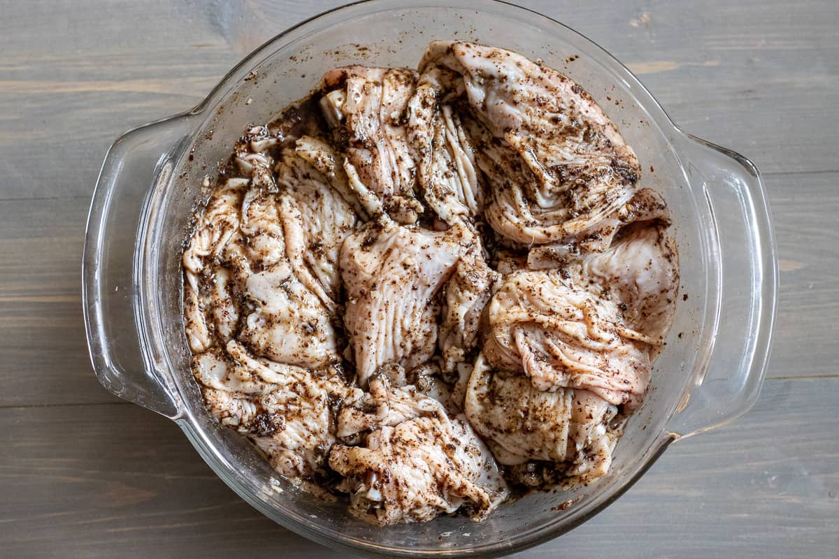 chicken pieces are covered with marinade