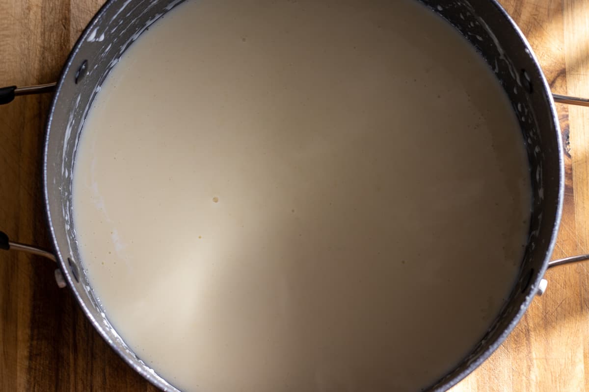 the milk is added slowly to the roux for making béchamel sauce