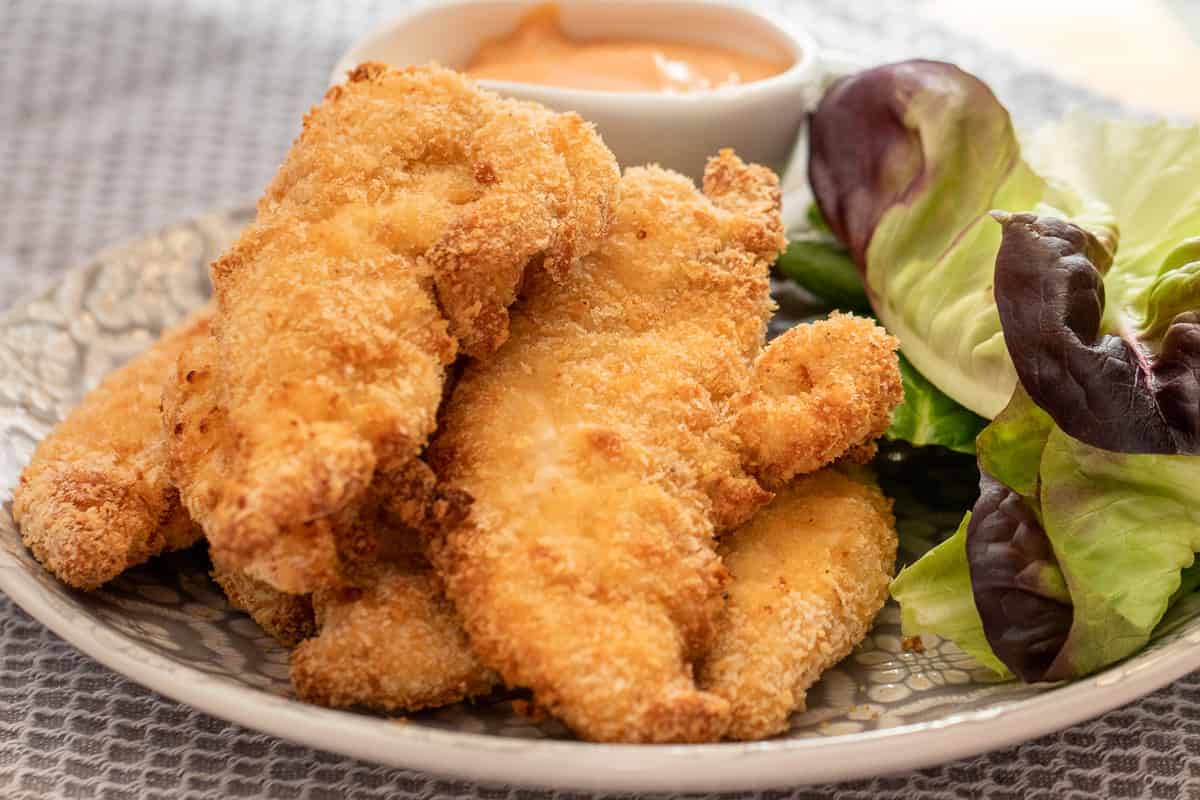 air fryer chicken tenders are served with salad and dip
