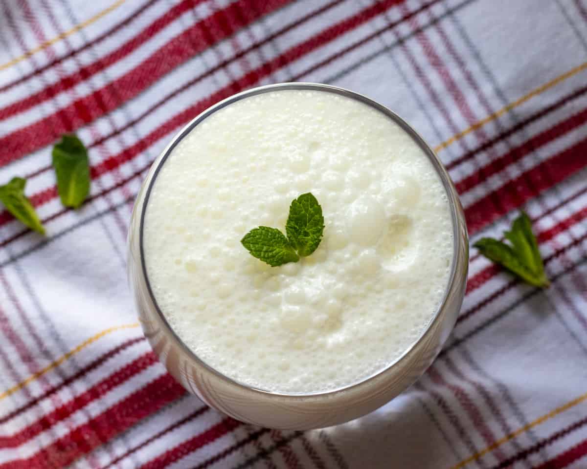 ayran is served in a glass with mint leaves