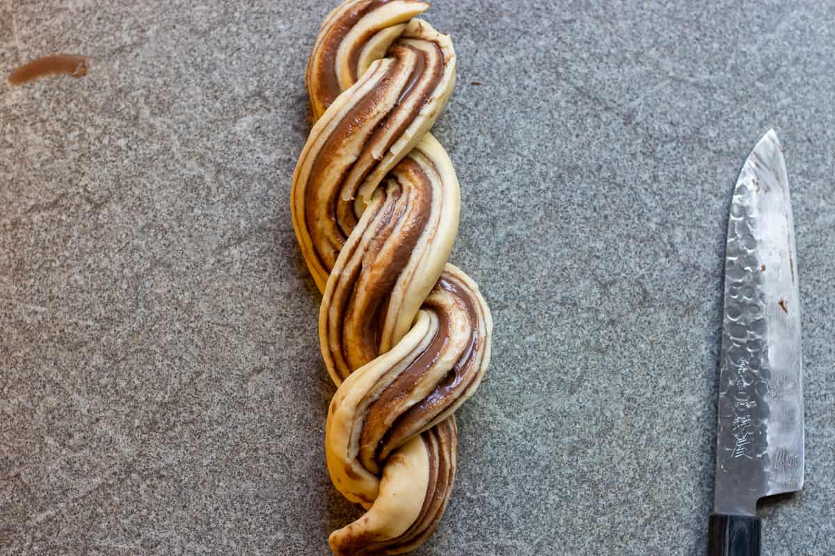 twisting the two halves together around each other for shaping the babka