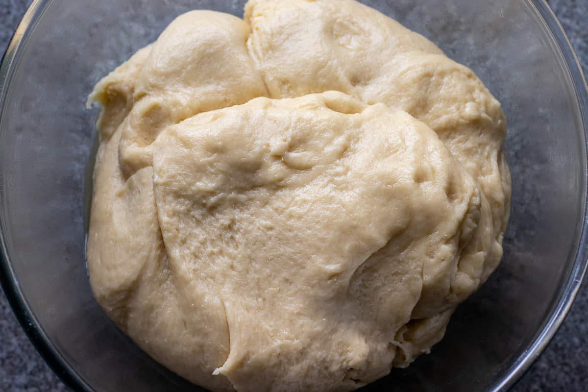 the chocolate Nutella babka bread dough is placed in a glass bowl for first rising
