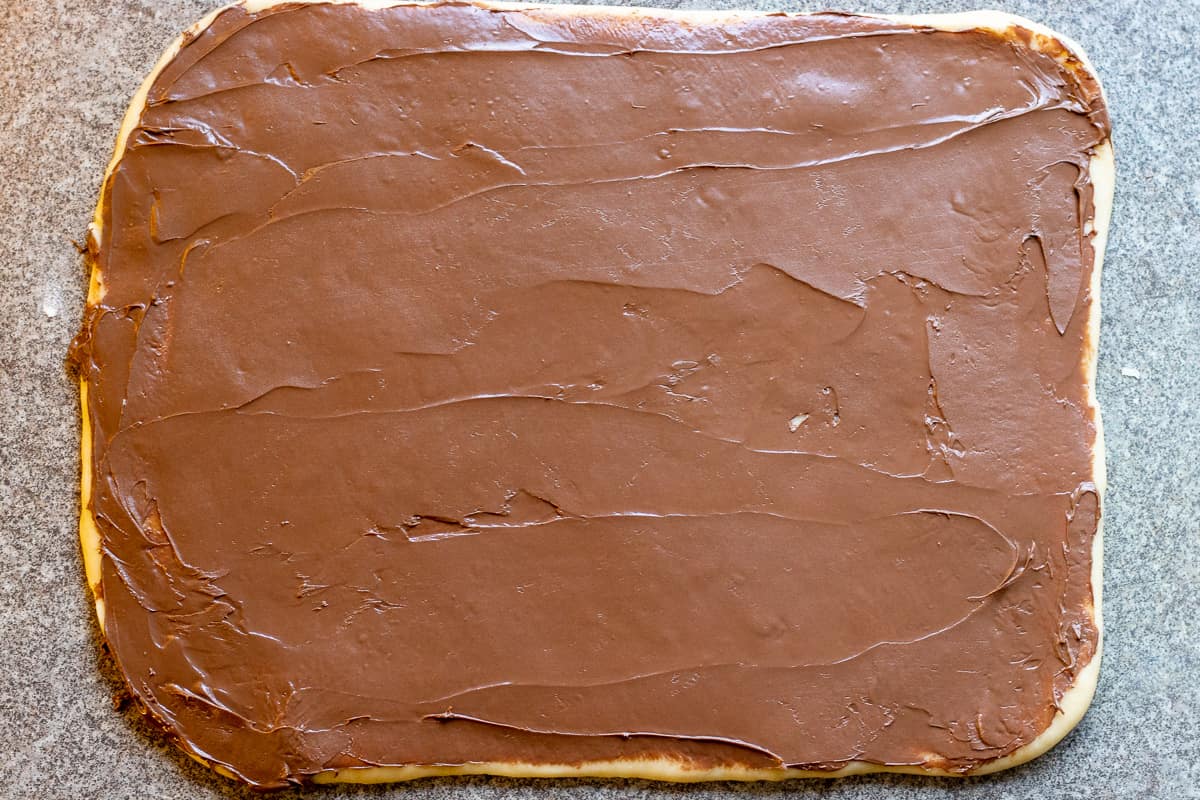 Nutella is spread on the dough