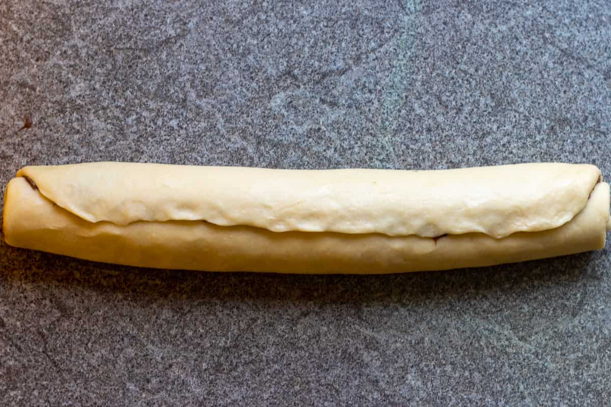 the rectangular dough is shaped into a log