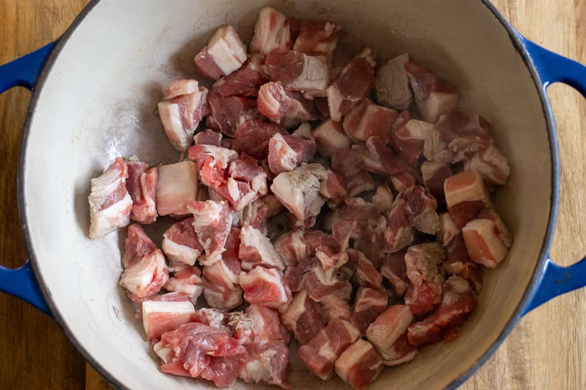 Sautéing the diced lamb with olive oil in a pan