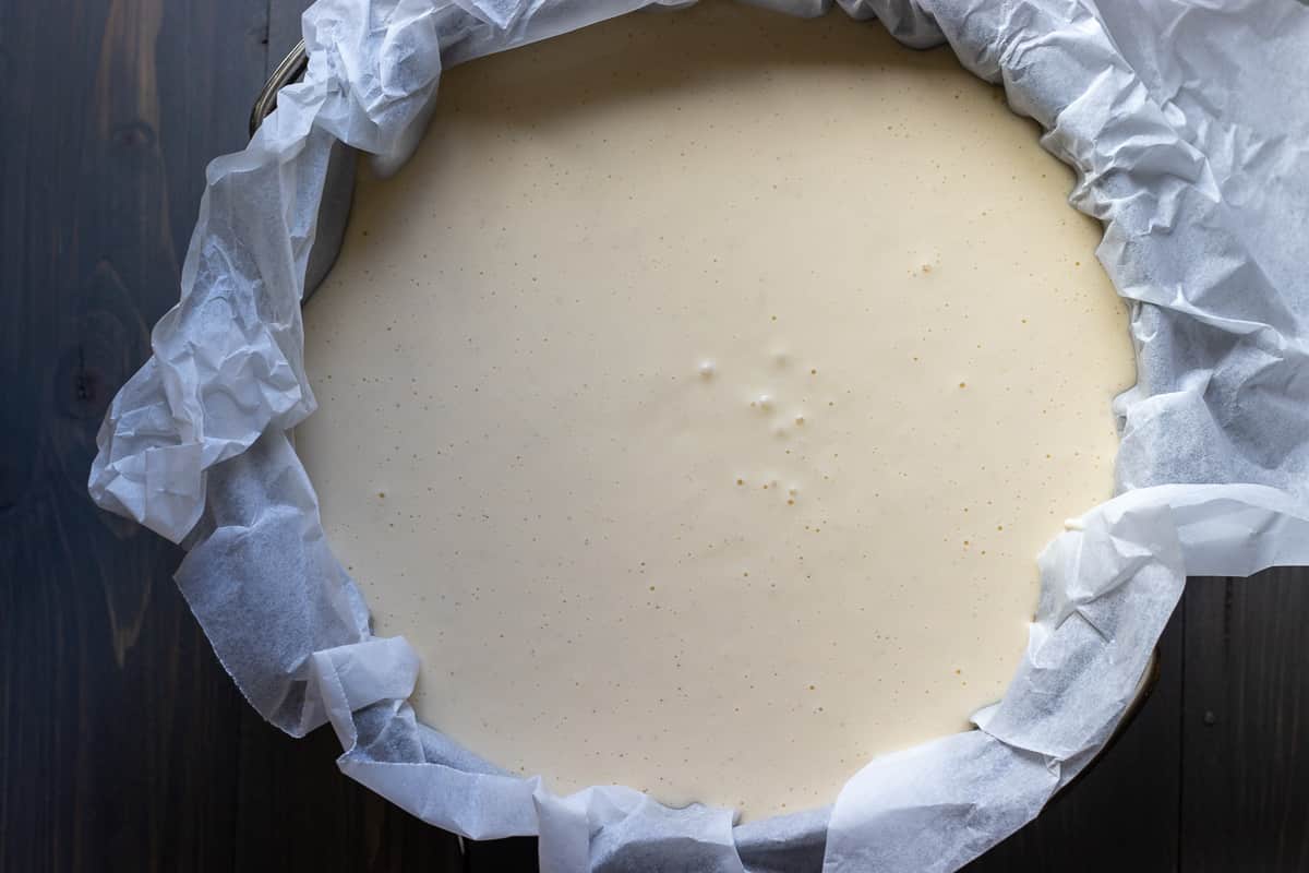 the cheesecake mixture is poured in cake tin