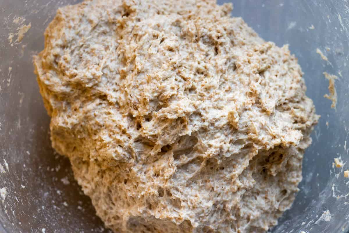 the flour is added to the yeast and water to form a sticky dough