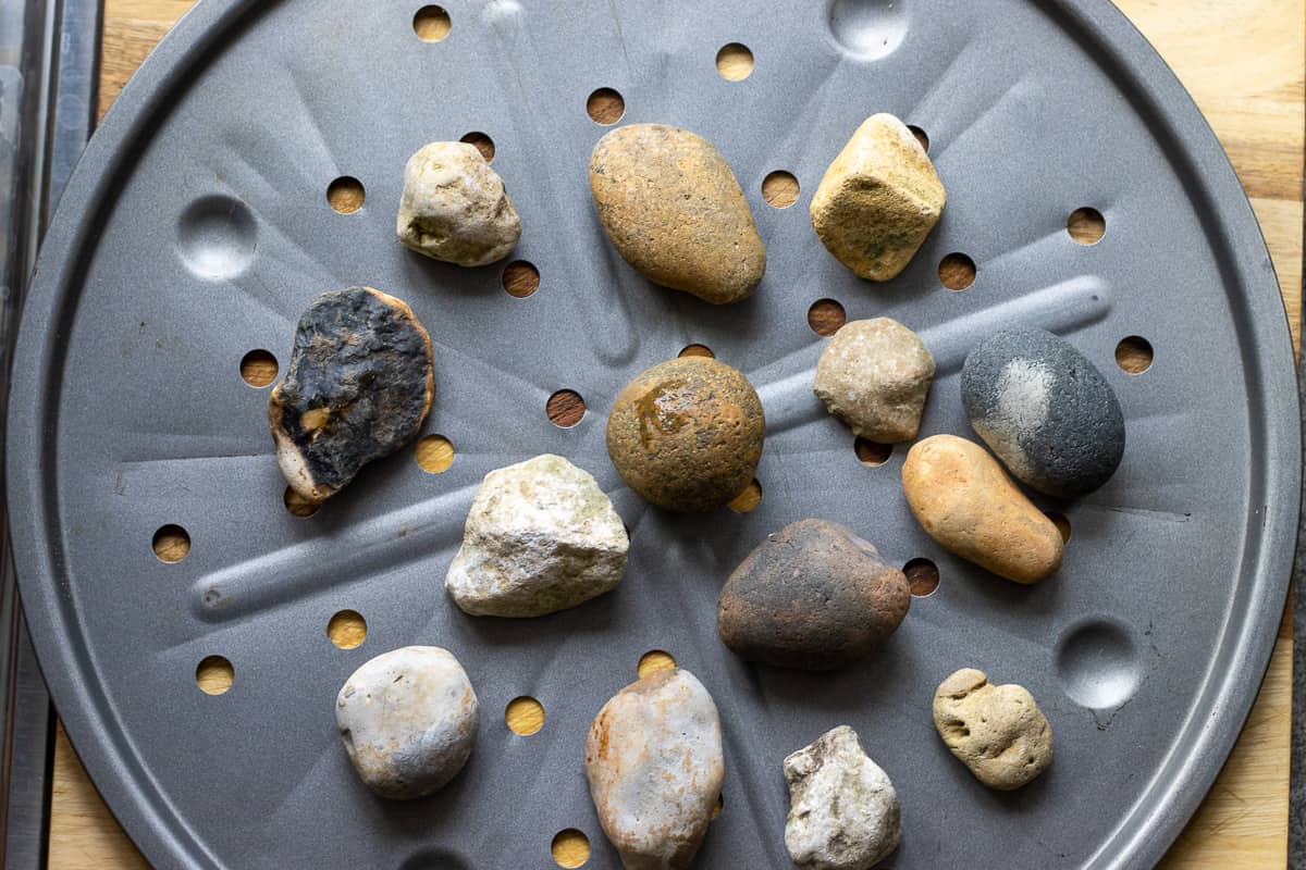 pebbles are placed on a baking tray