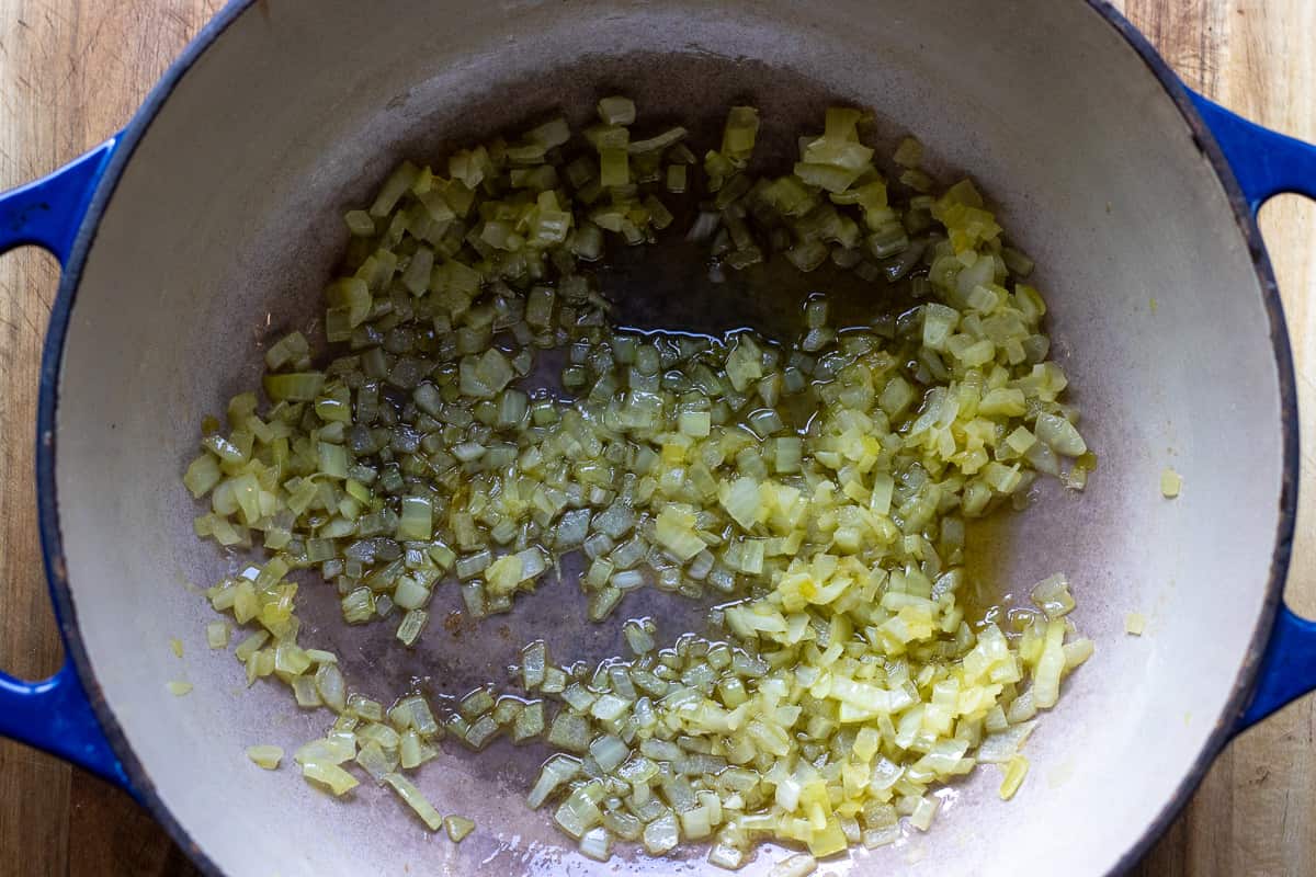 Sautéing the onions in a Dutch oven with olive oil