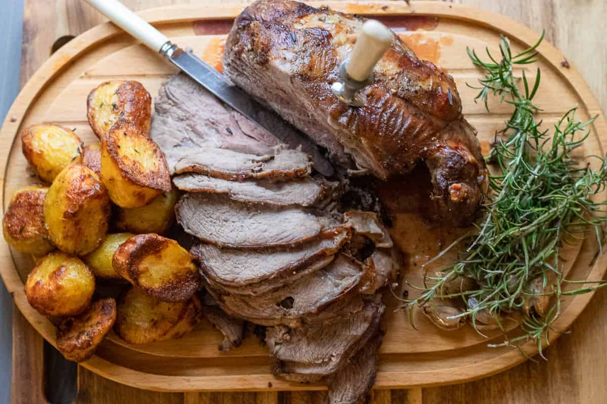 sliced leg of lamb roast with duck fat roasted potatoes