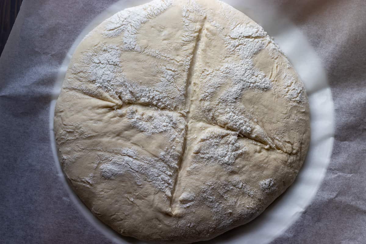 the dough has been scored with a sharp knife