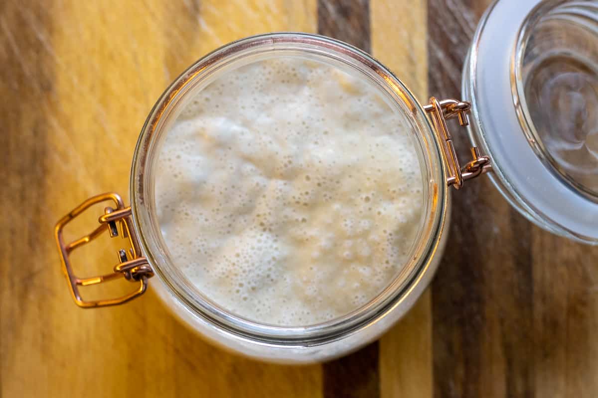 Active and bubbly sourdough starter in a mason jar.