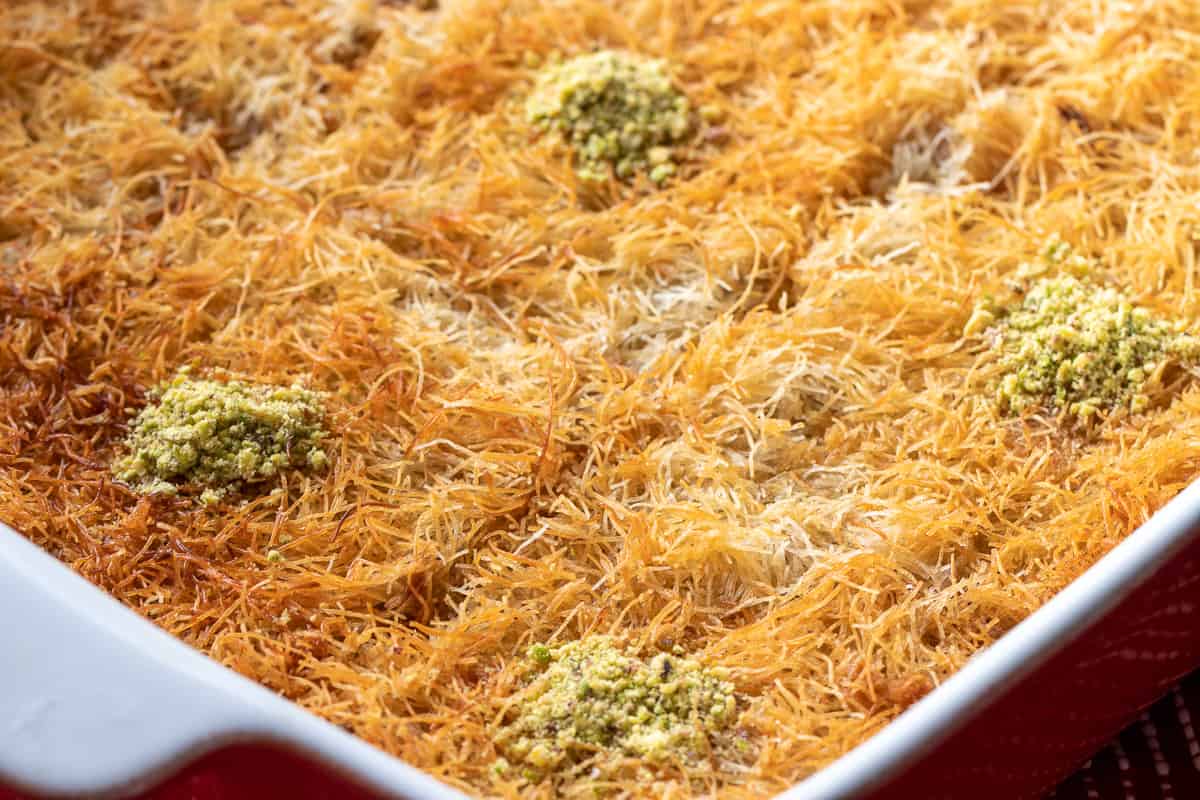 freshly made kadaif dessert portioned and garnished with pistachio