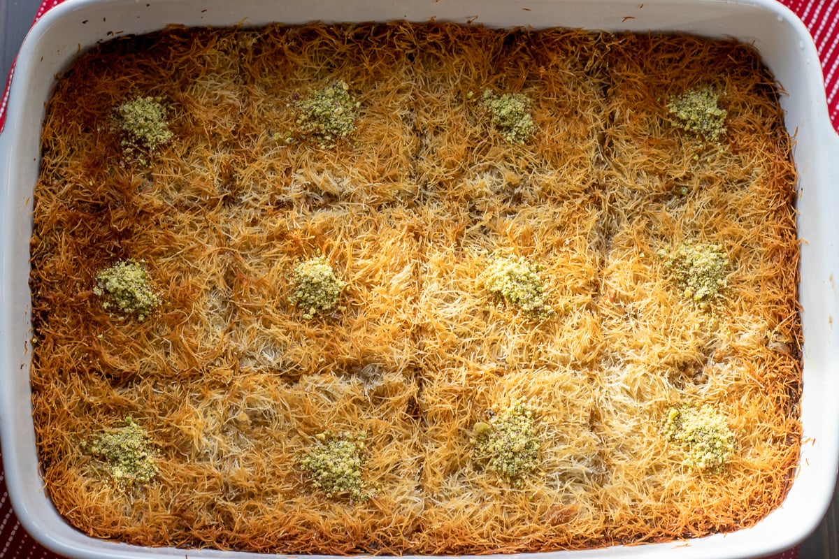 kadayıf dessert is garnished with chopped pistachio