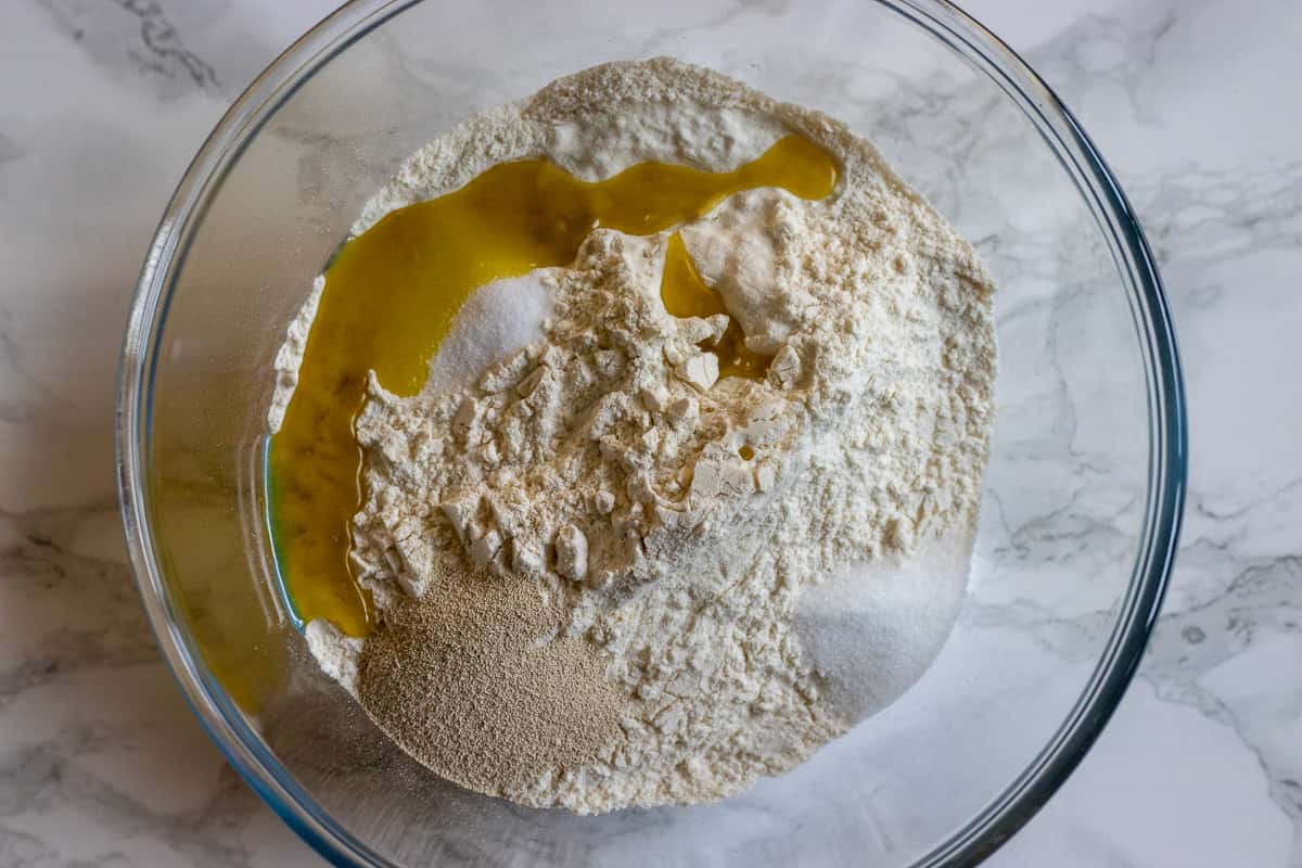 flour, olive oil, salt,sugar and yeast are placed in a bowl for making manakish dough