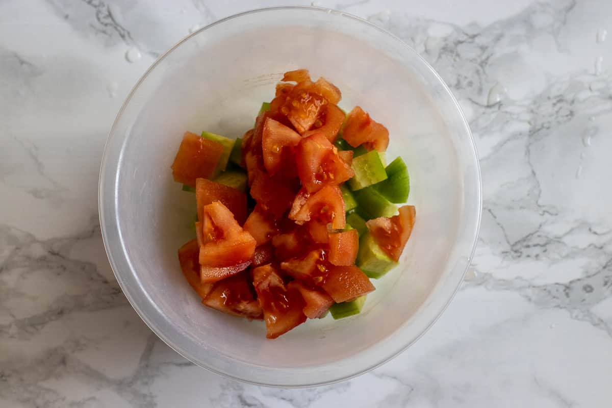 diced tomatoes are added to cucumbers