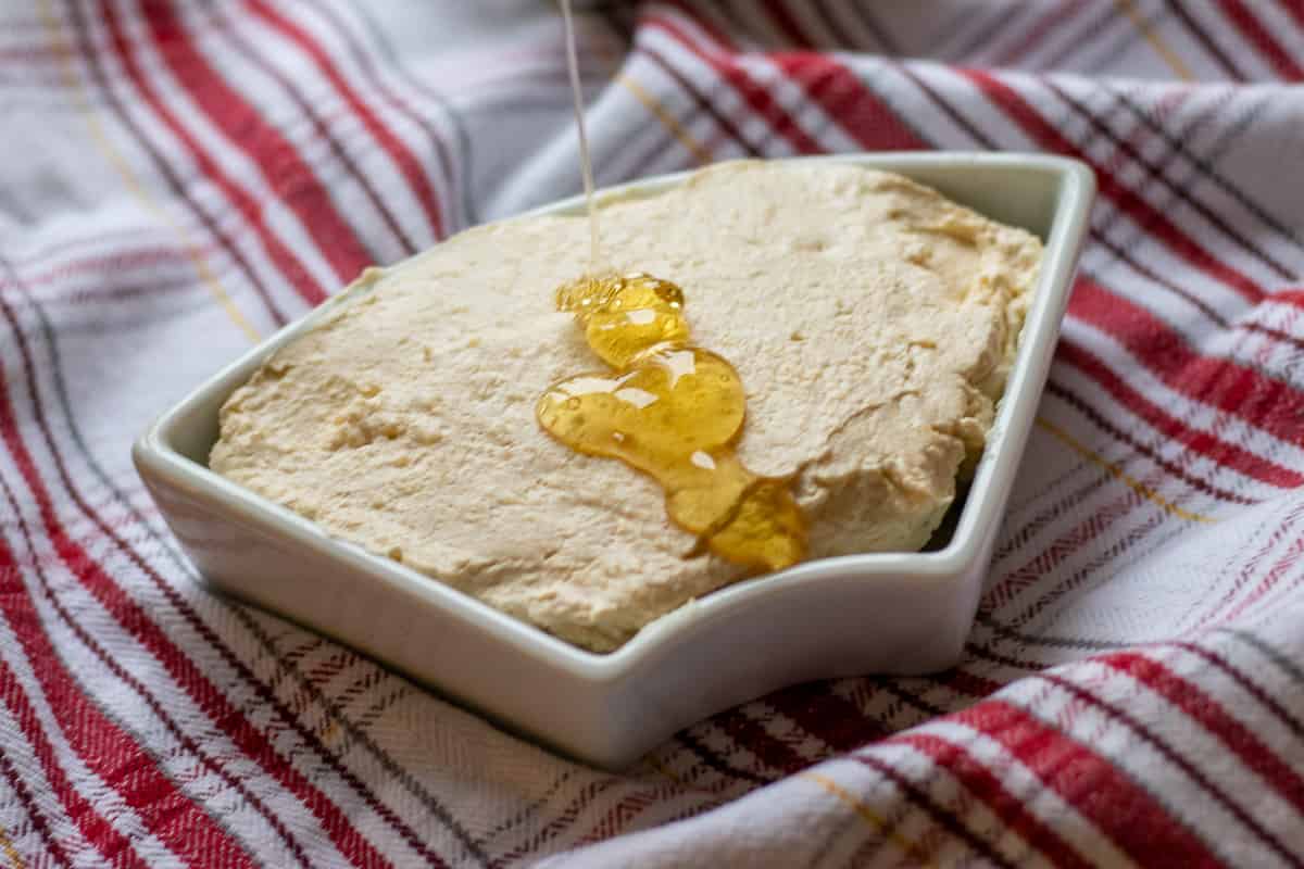turkish kaymak -geymar is placed on a bowl and served with honey