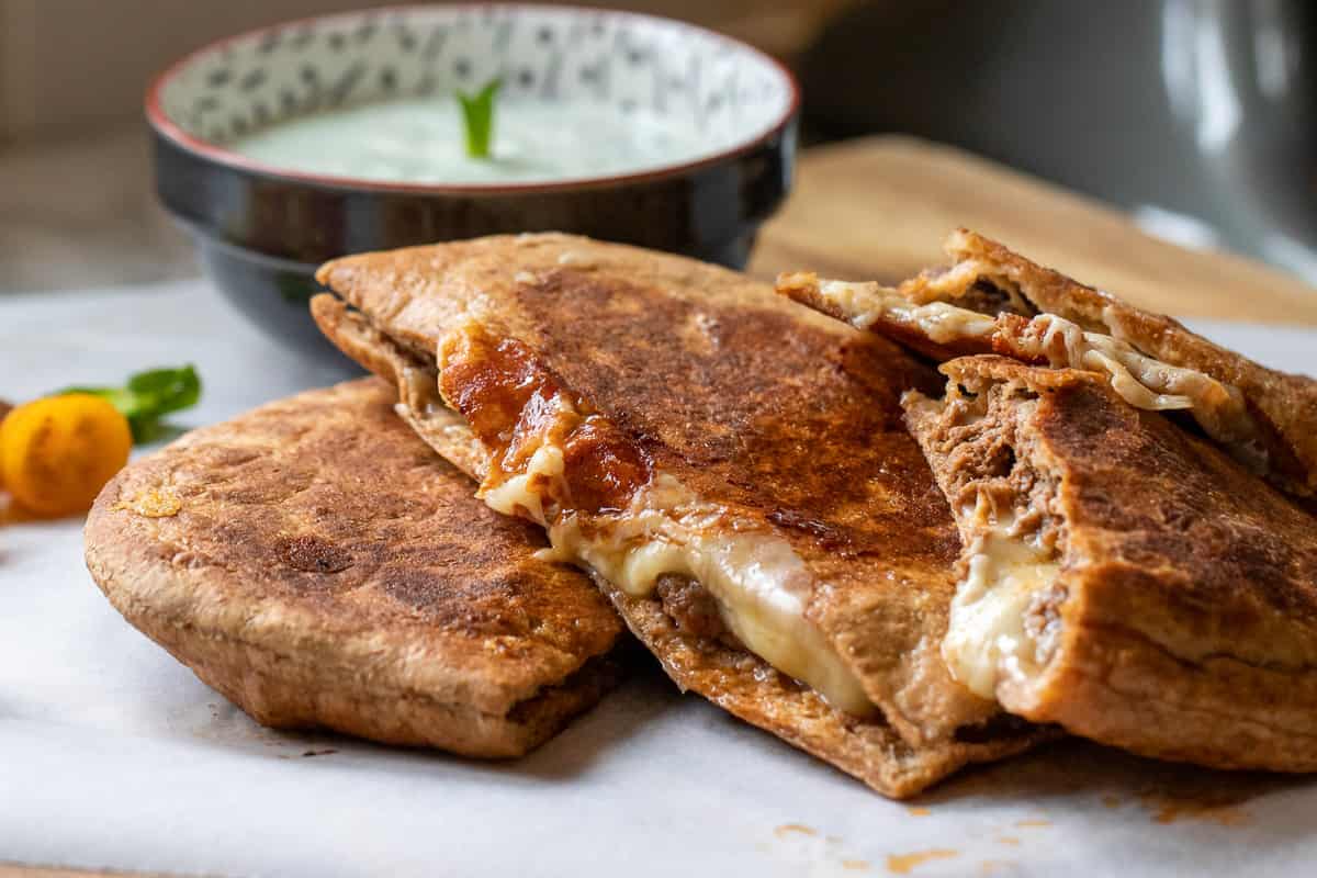 arayes is served with a bowl of mint yogurt sauce on the side