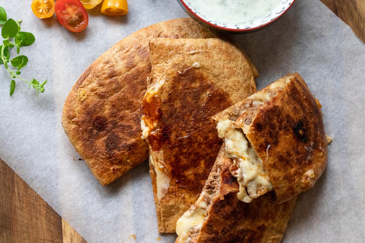 3 pieces of arrays served with yogurt sauce and salad
