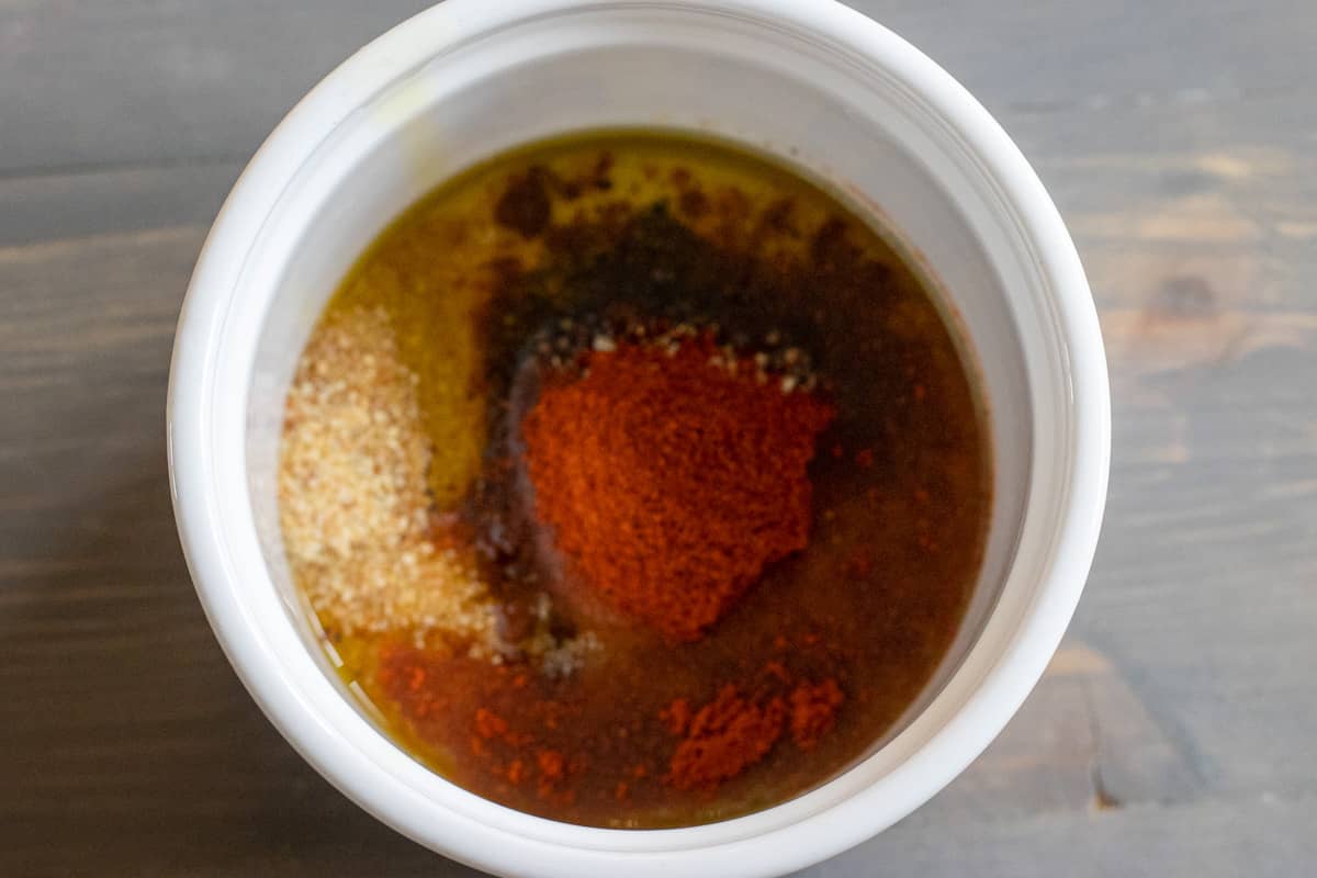 the seasoning and olive oil are placed in a bowl