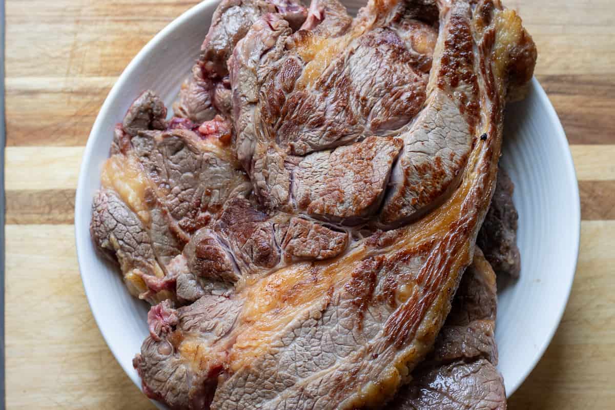 chuck roast is set aside on a plate