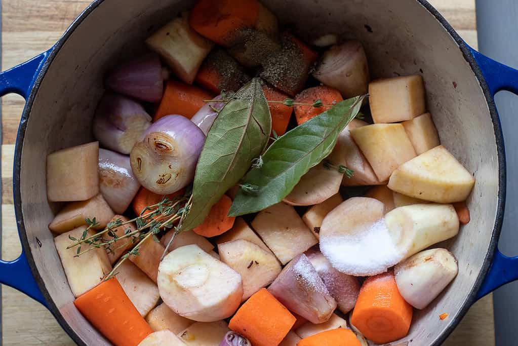 The pan is deglazed with red wine before adding the seasoning.