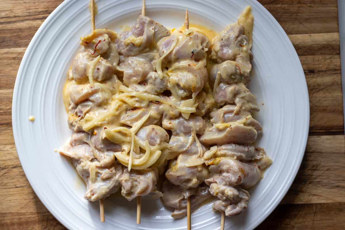 chicken pieces are threaded onto bamboo skewers