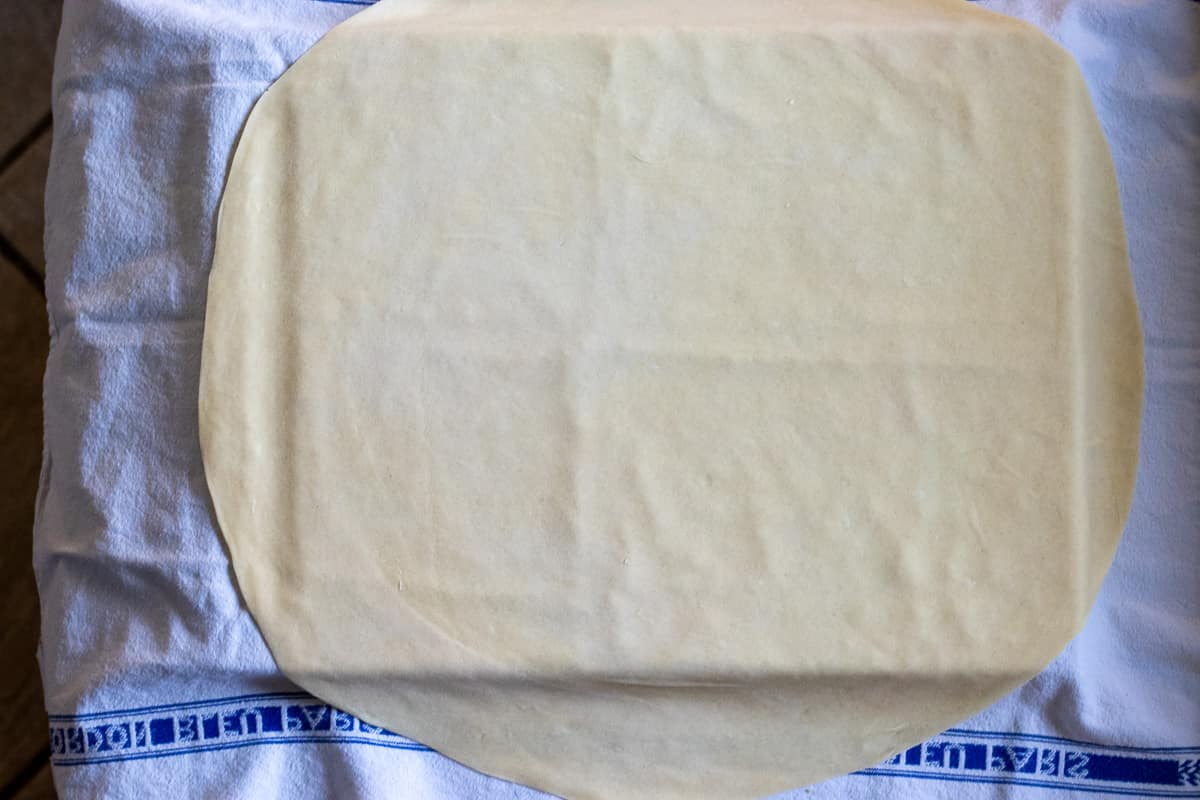 the dough is rolled out into a large circle