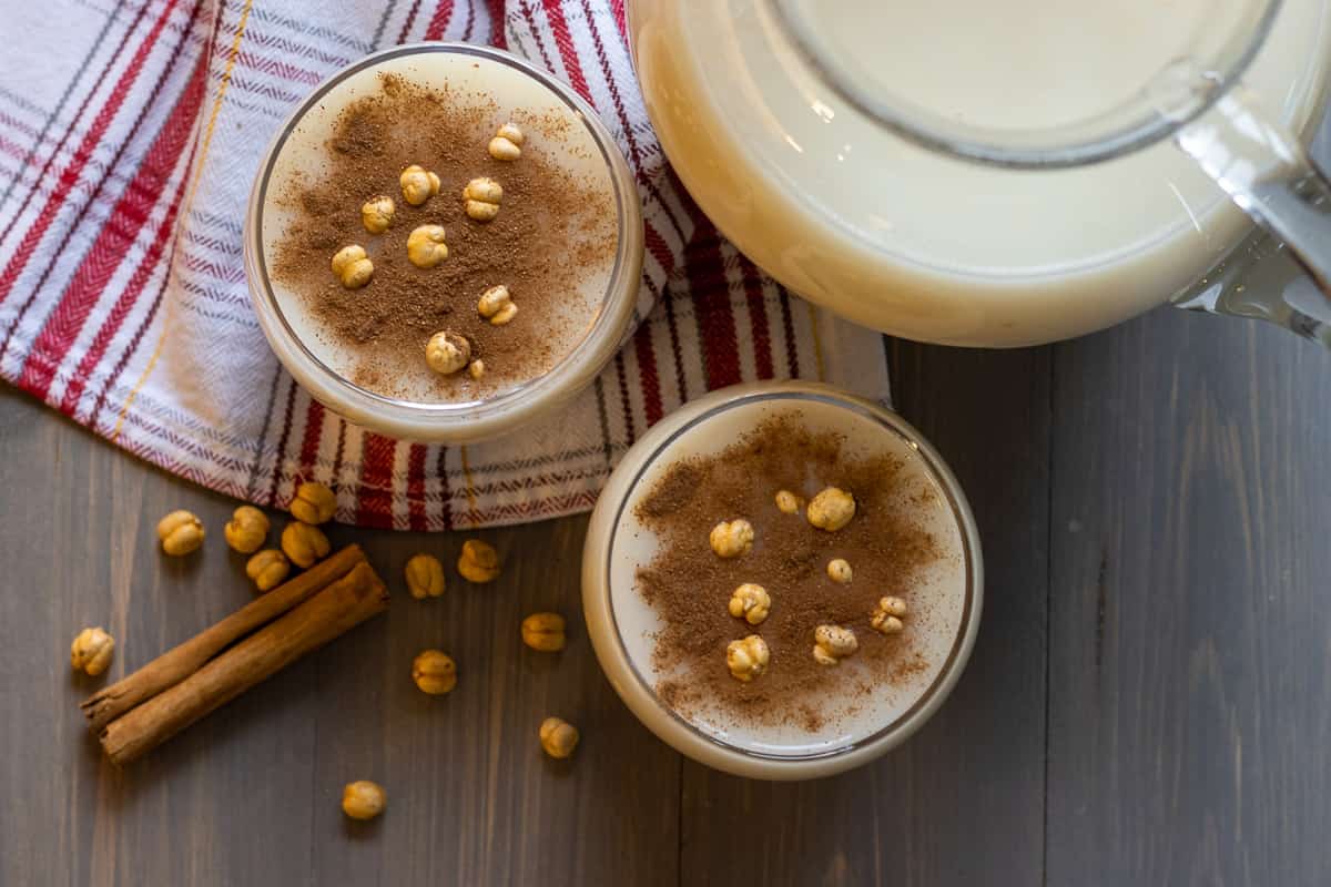 Turkish boza drink served with cinnamon and roasted chickpeas