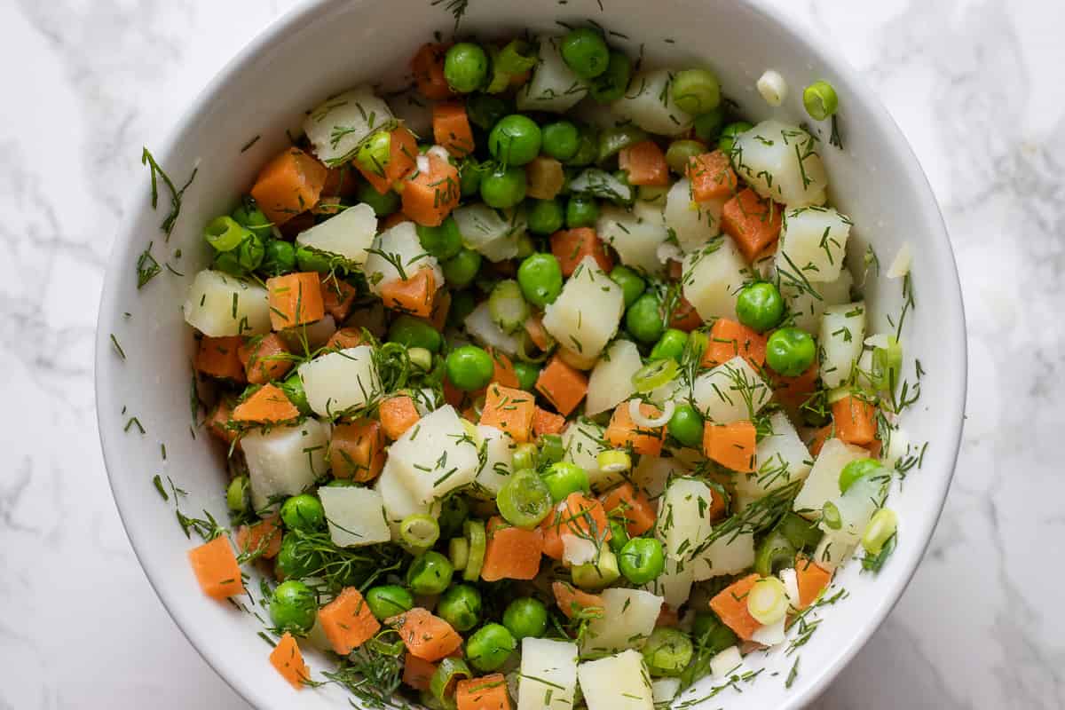 spring onion and dill are added to the cooked vegetables